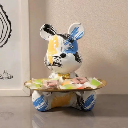 Graffiti bear figurine with blue, black and yellow brush strokes and a gold candy tray on Tampa Home & Garden Store