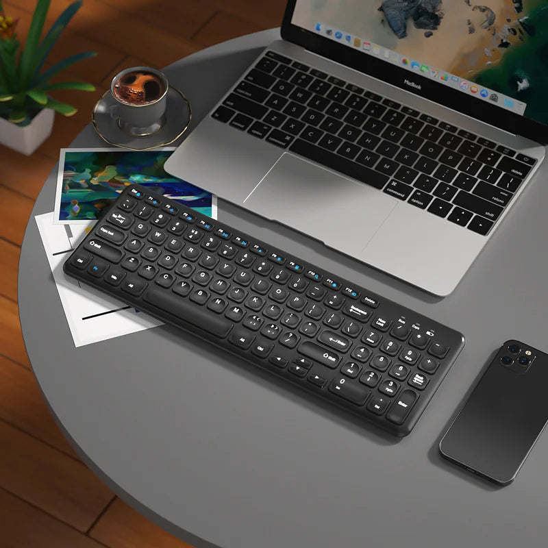 FLIPSTYLEZLLC black wireless keyboard and mouse set with blue accents, near laptop on Tampa Home & Garden Store