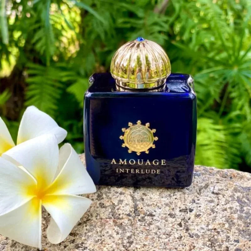 AMOUAGE Interlude perfume bottle in deep navy glass with a gold ornate cap and crest on Tampa Home & Garden Store