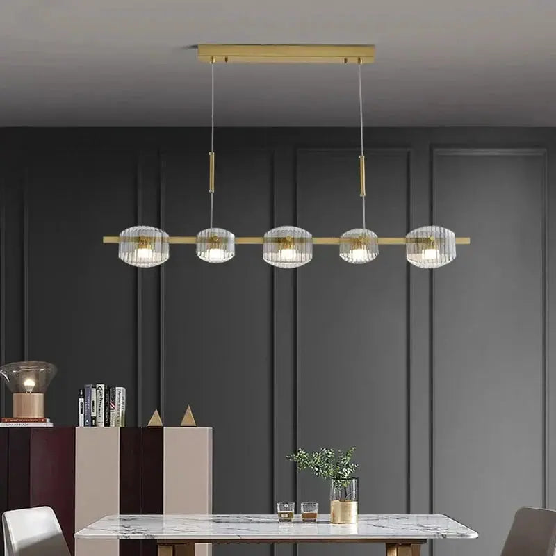 DecorBites LED pendant chandelier with five glass globe shades on a gold brass bar on Tampa Home & Garden Store