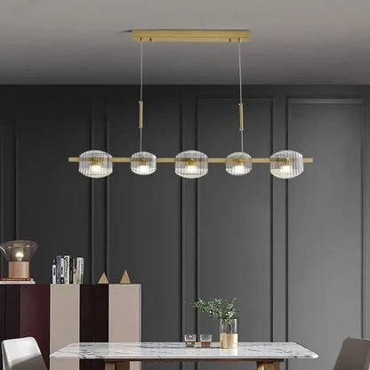 DecorBites LED pendant chandelier with five glass globe shades on a gold brass bar on Tampa Home & Garden Store