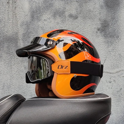 Retro motorcycle helmet in orange and black flame graphics with clear visor on Tampa Home & Garden Store