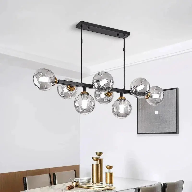 Decorbites LED pendant chandelier with seven globes on a black metal bar with brass accents on Tampa Home & Garden Store