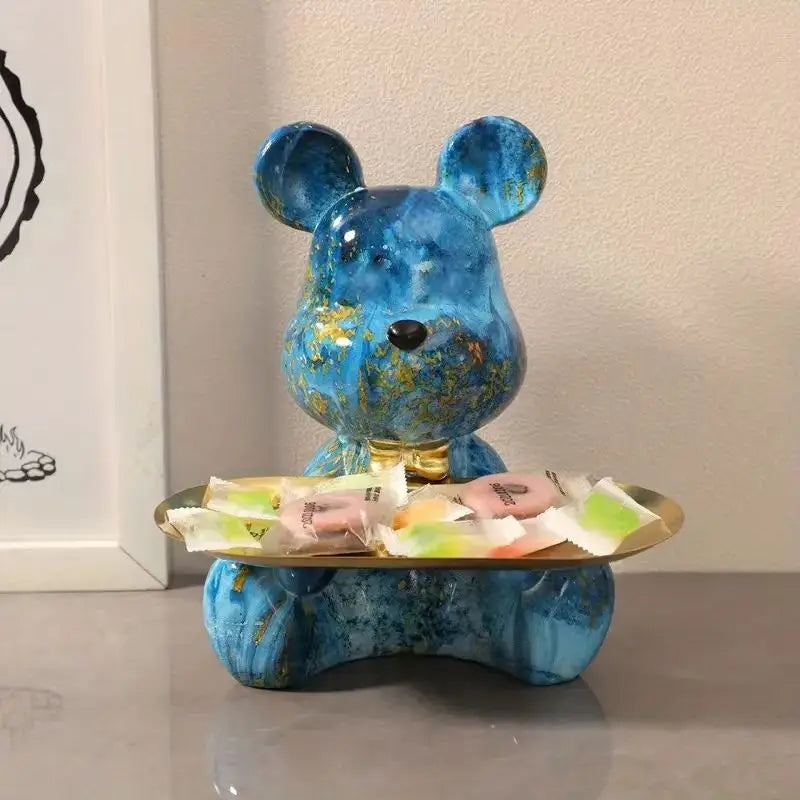 Blue graffiti bear figurine holding a gold tray with wrapped candies for shelf display on Tampa Home & Garden Store