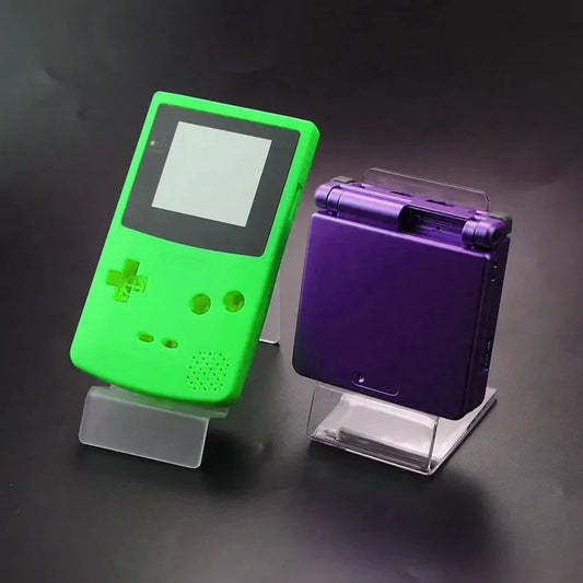 Clear acrylic display stand for game consoles; two Game Boy-style lime green and purple GBA SP on Tampa Home & Garden Store