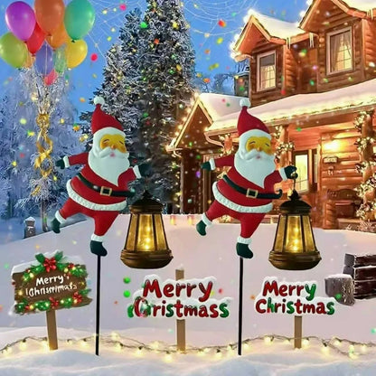 Two Santa Claus solar kettle garden lanterns in a snowy yard with Merry Christmas signs on Tampa Home & Garden Store