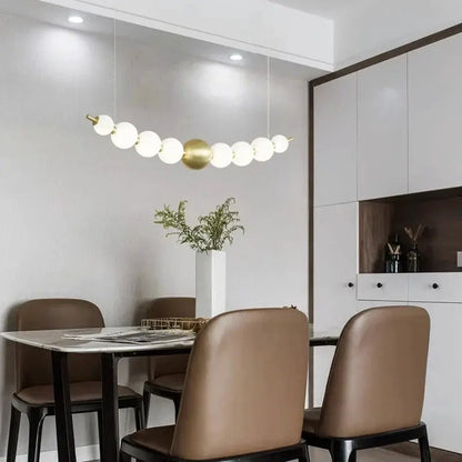 DecorBites LED pendant chandelier with curved white globe lights and brass center orb on Tampa Home & Garden Store