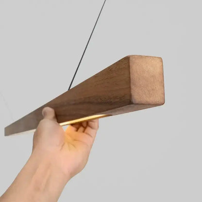DecorBites Linear LED Pendant Light in walnut wood, rectangular block with warm glow on Tampa Home & Garden Store