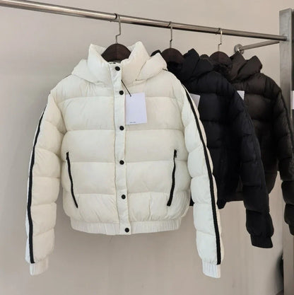 White hooded puffer jacket for women with thick padding and zip pockets; 4 jackets on rack on Tampa Home & Garden Store