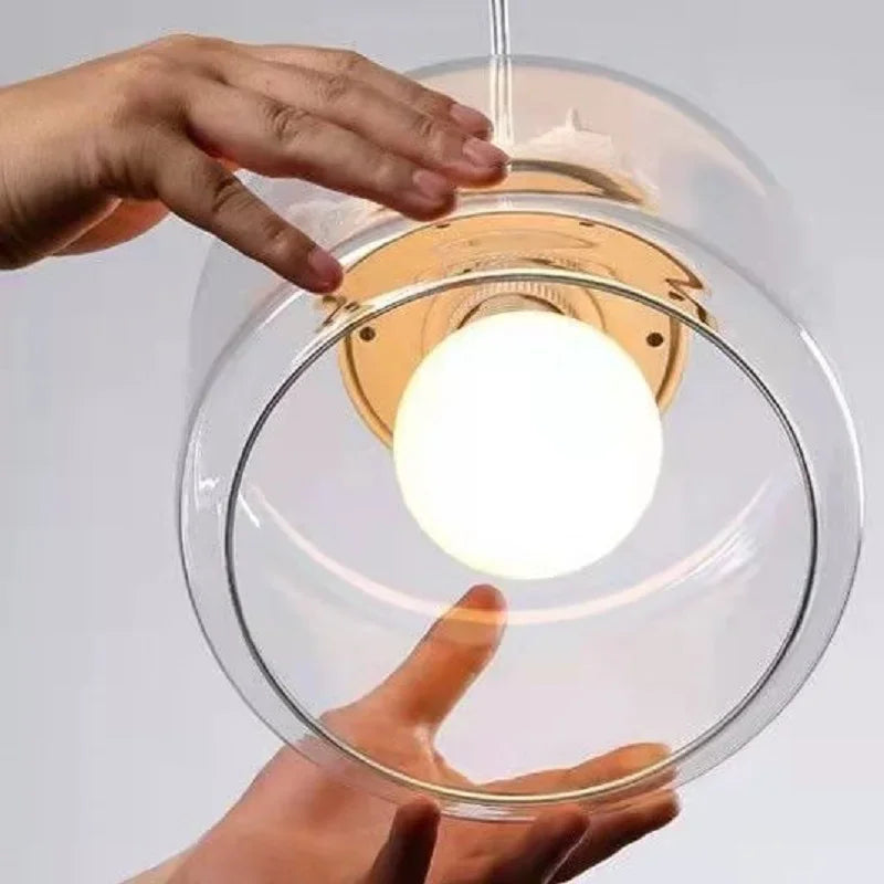 Birds glass pendant light with circular glass ring around a frosted LED bulb, gold mount on Tampa Home & Garden Store