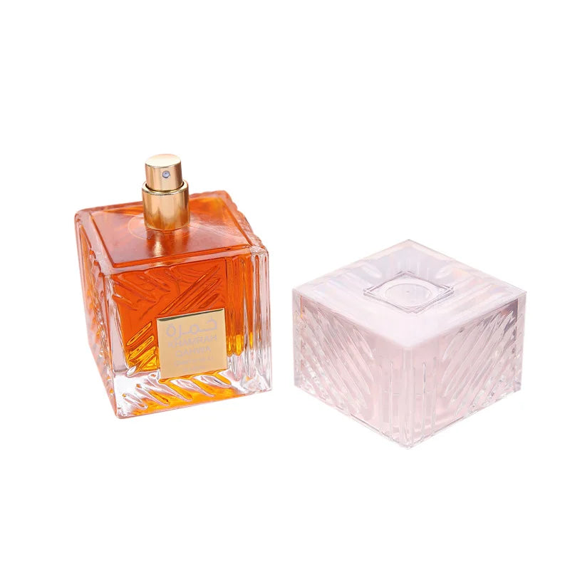 Khamrah perfume bottle square glass with orange liquid, gold spray top, pink cap beside on Tampa Home & Garden Store