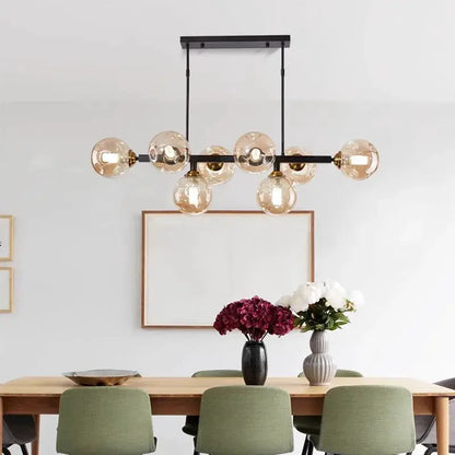 DecorBites LED pendant chandelier with black metal frame and amber glass globes over a dining table on Tampa Home & Garden Store