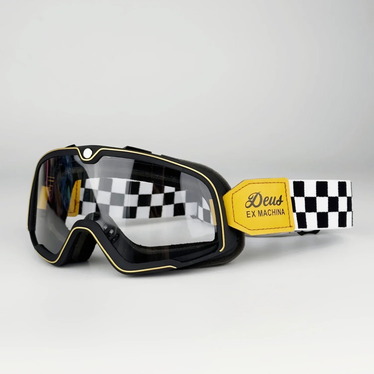 Retro Goggles Motocross with black frame and gold trim, checkered strap with Deus Ex Machina patch on Tampa Home & Garden Store