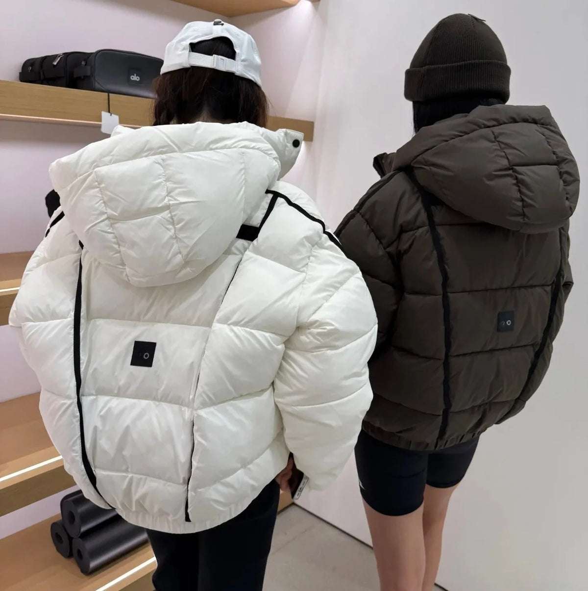 White and brown hooded puffer coats for women, thick warm padded jackets with small logo patches on Tampa Home & Garden Store