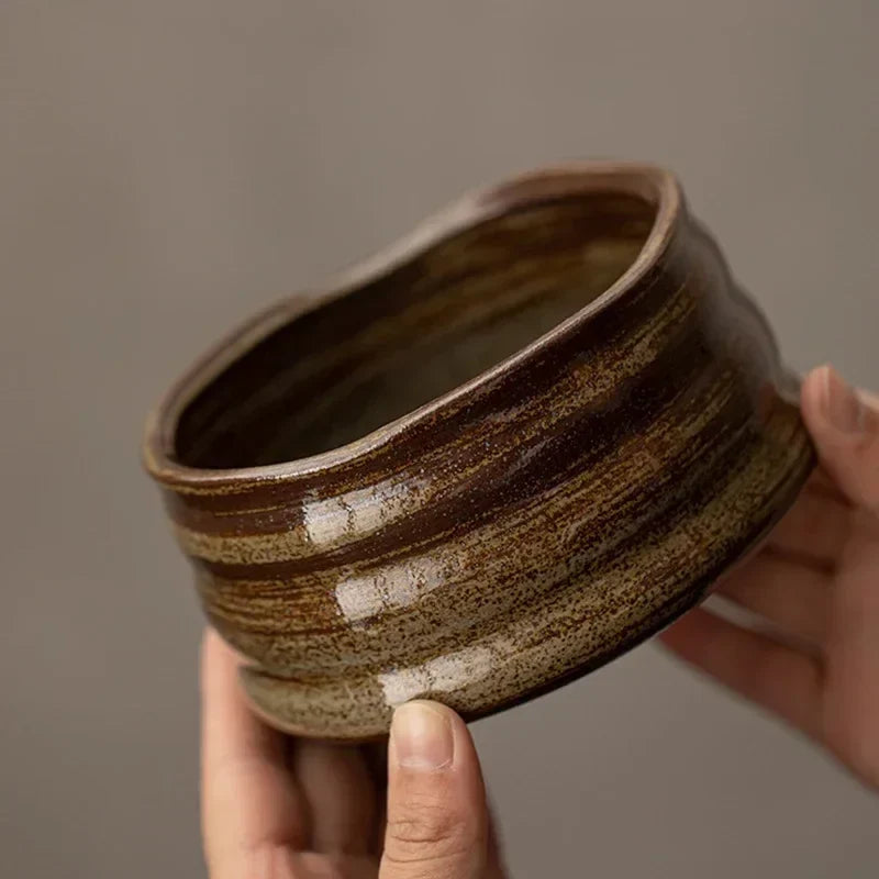 Perfecsy ceramic matcha bowl with brown speckled glaze for tea ceremony held by hands on Tampa Home & Garden Store