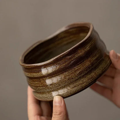 Perfecsy ceramic matcha bowl with brown speckled glaze for tea ceremony held by hands on Tampa Home & Garden Store