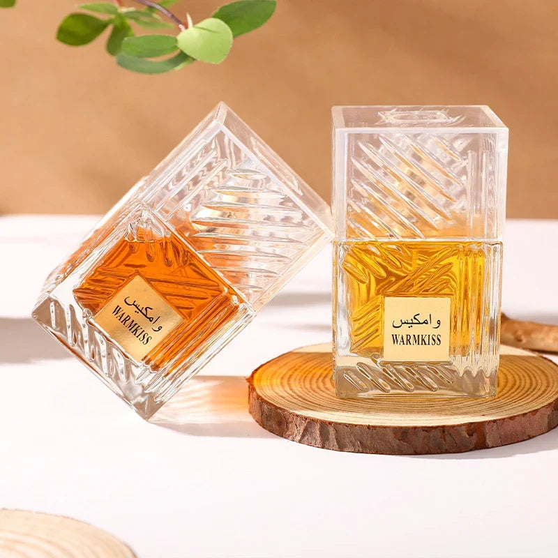 Khamrah perfume bottles, two crystal glass bottles with amber liquid on a wooden coaster on Tampa Home & Garden Store