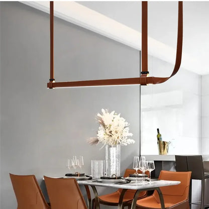 DecorBites LED Art Deco chandelier in brown leather straps over a marble dining table on Tampa Home & Garden Store