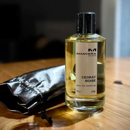 Mancera Cedrat Boise perfume bottle with yellow liquid and black cap beside a pouch 120 ml on Tampa Home & Garden Store