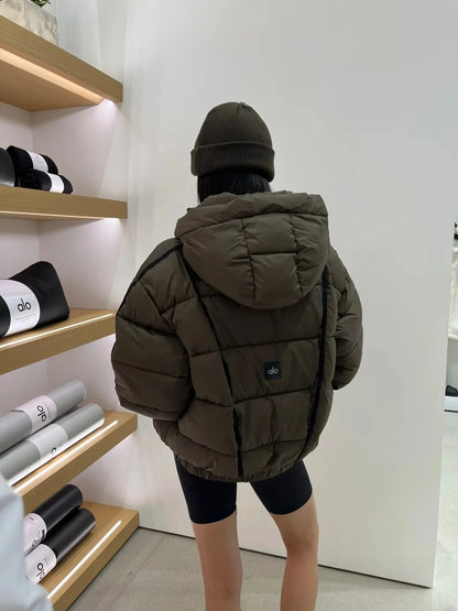 Olive green women's hooded puffer jacket with thick quilted panels and alo logo patch on back on Tampa Home & Garden Store