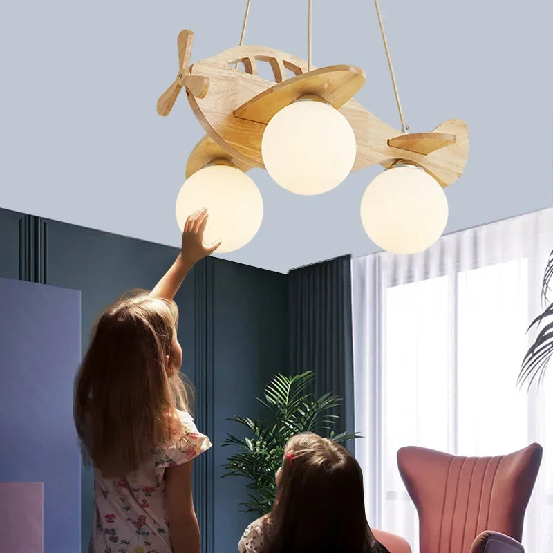DecorBites Kids Wood Airplane Chandelier with three glowing LED globe bulbs on Tampa Home & Garden Store
