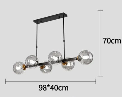DecorBites LED pendant chandelier with 6 clear glass globes on a black bar, gold accents on Tampa Home & Garden Store