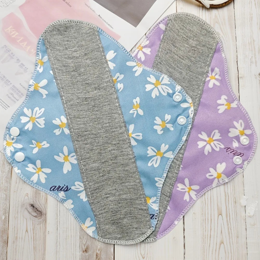 Two Silcy Skin reusable cloth panty liners with blue-purple daisy-print fabric on Tampa Home & Garden Store