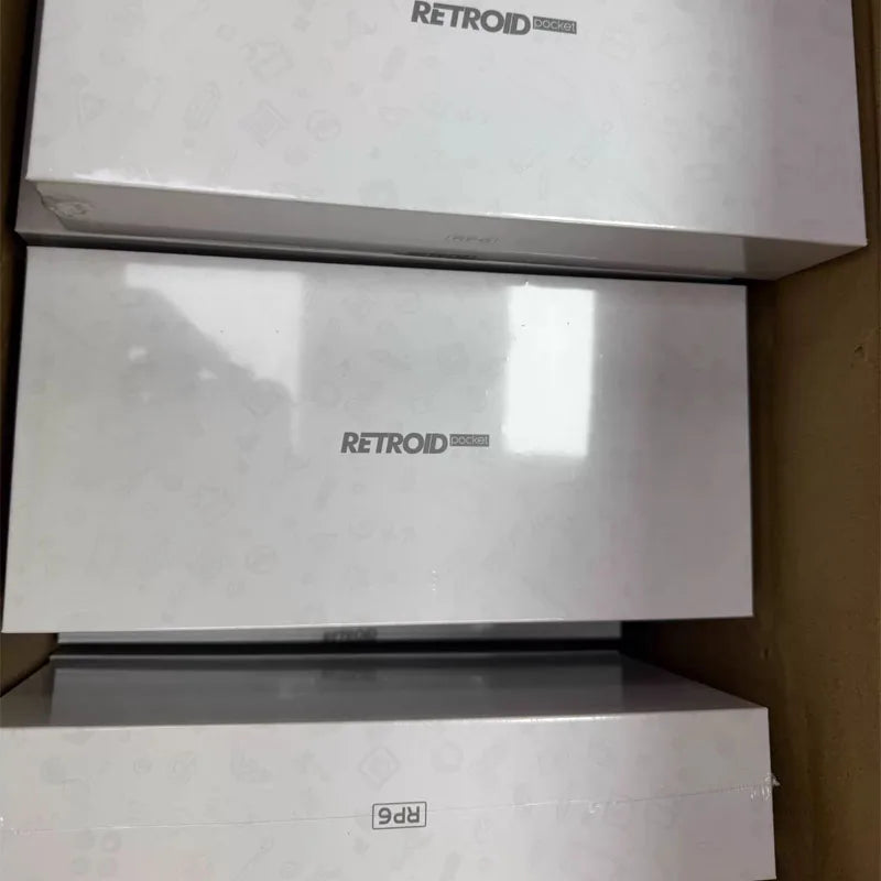 Three white Retroid Pocket 6 boxes with RP6 logo, stacked in a carton on Tampa Home & Garden Store