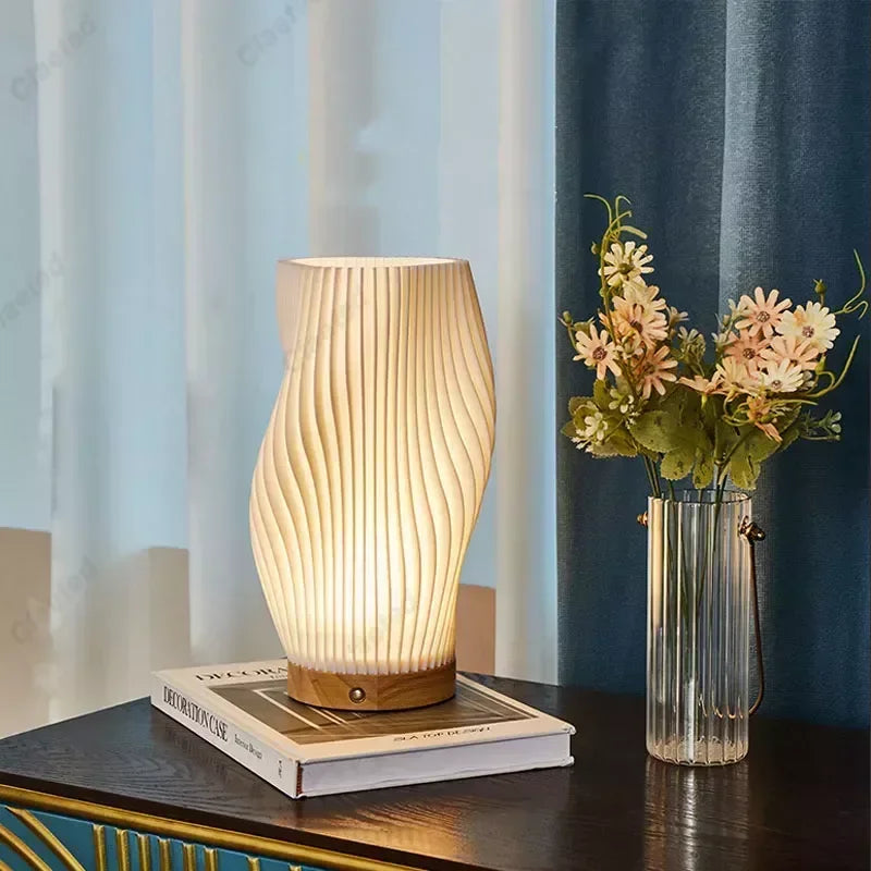 Wood table lamp with white wave-ribbed shade and dimmable LED on a dark table on Tampa Home & Garden Store