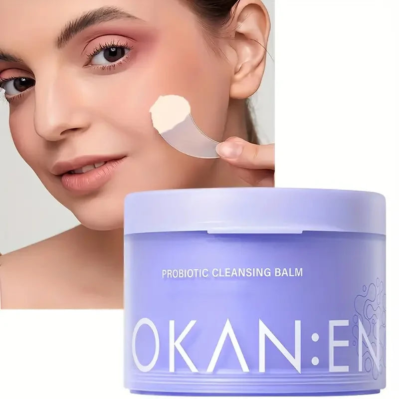 Probiotic cleansing balm by OKAN:E in lavender jar; model removes makeup with balm on Tampa Home & Garden Store