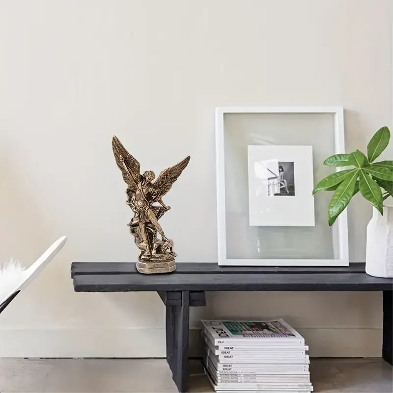 Perfecsy Saint Michael resin statue on dark wood console with framed art and plant on Tampa Home & Garden Store