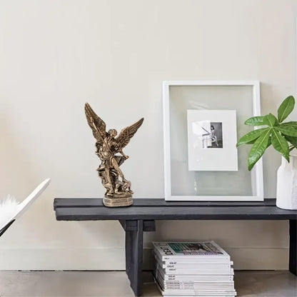 Perfecsy Saint Michael resin statue on dark wood console with framed art and plant on Tampa Home & Garden Store