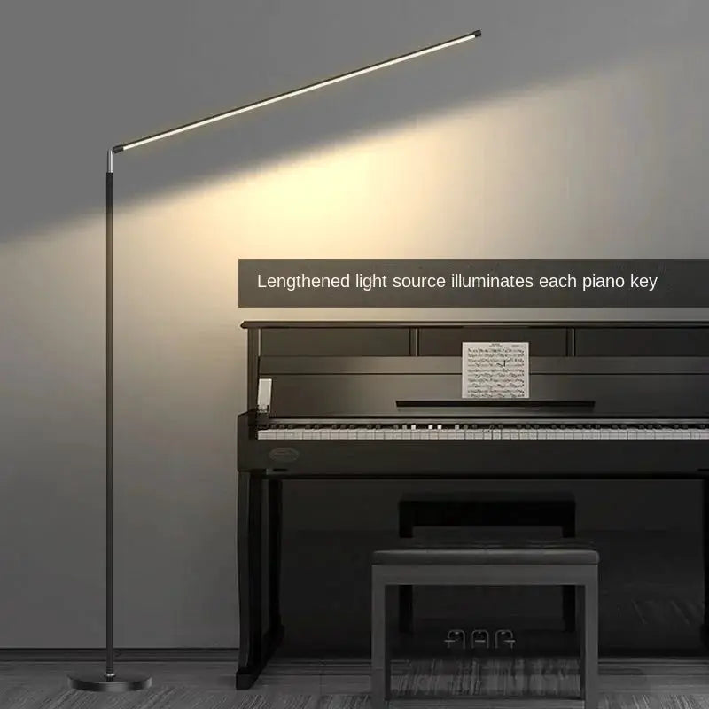 DecorBites LED floor lamp slim metal frame with long LED bar lighting a piano in a living room on Tampa Home & Garden Store