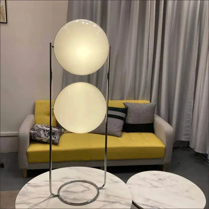DecorBites floor lamp with chrome frame and two white acrylic globe balls in living room on Tampa Home & Garden Store