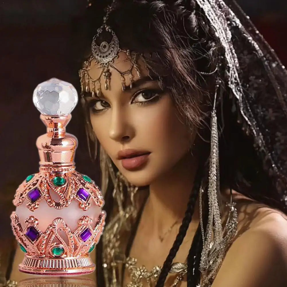 Exotic Arabian perfume bottle with rose-gold finish and jewel accents beside headpiece on Tampa Home & Garden Store