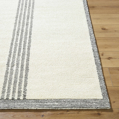 Ande Ivory Area Rug by Boutique Rugs with ivory pile and charcoal striped border on wood floor on Tampa Home & Garden Store