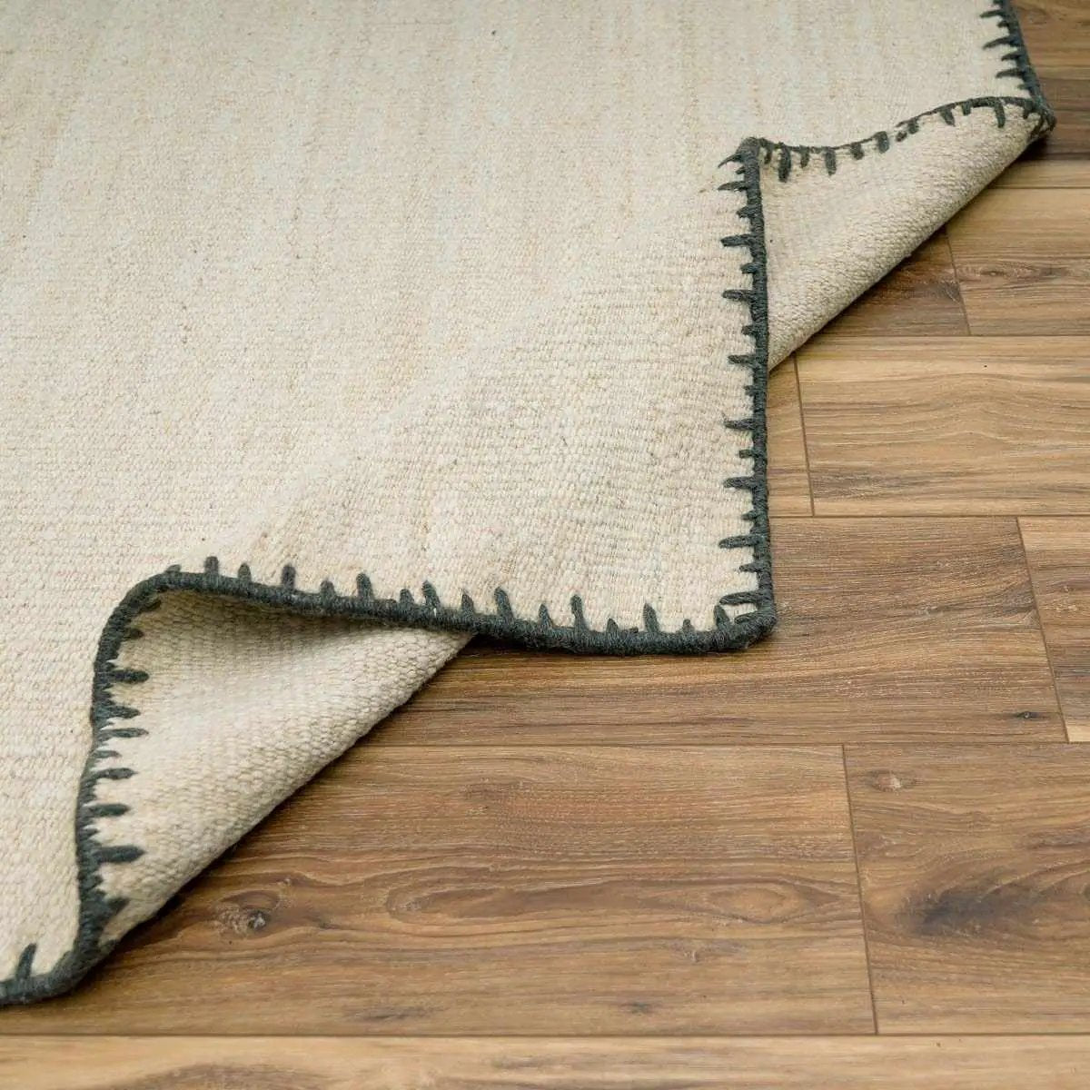 Ayumu off white hand woven wool area rug with charcoal edge trim Boutique Rugs clearance on Tampa Home & Garden Store
