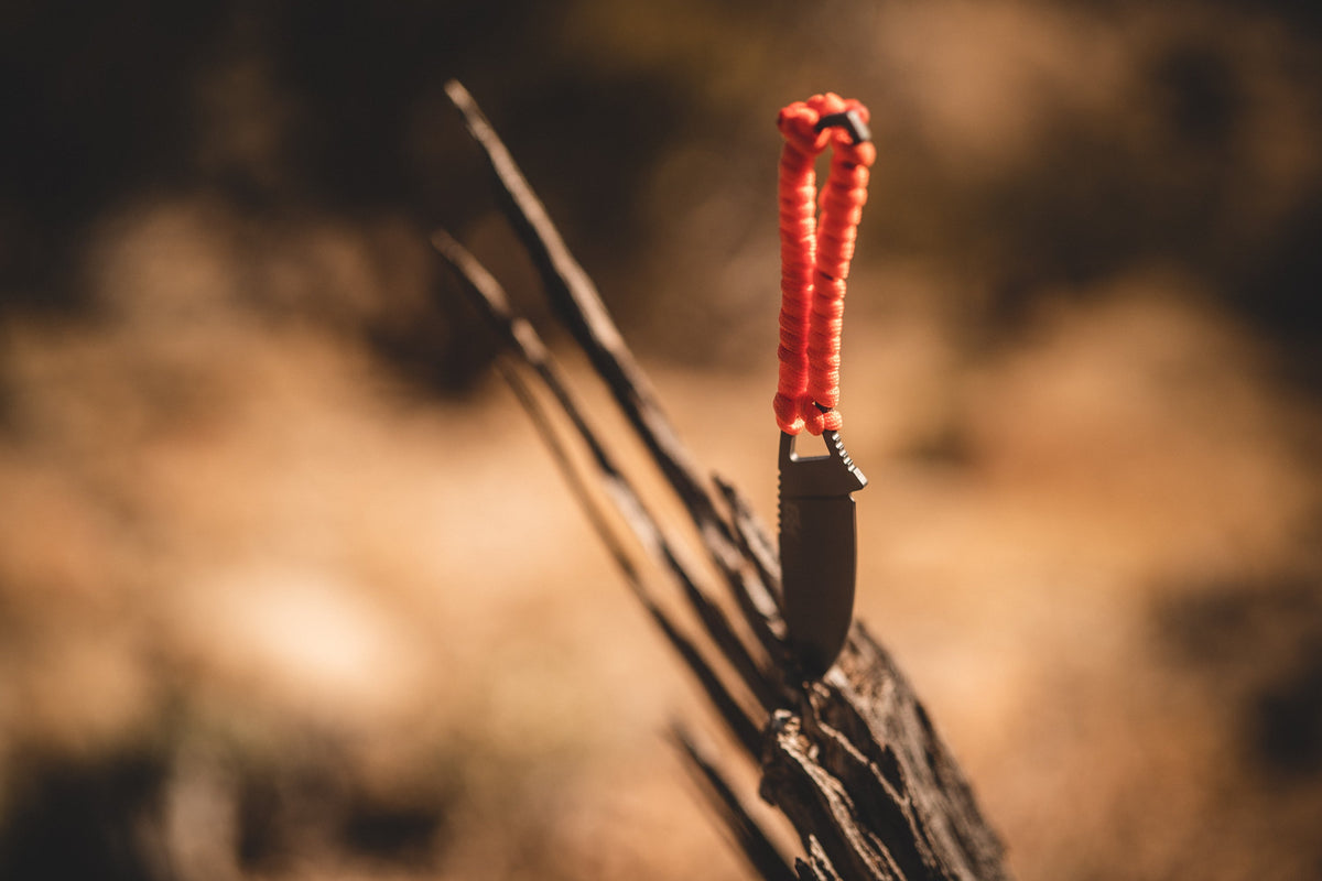 Ultralight Ridge Blade knife by Ridge Belts with red paracord lanyard on rugged wood on Tampa Home & Garden Store