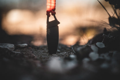 Ultralight Ridge Blade knife by Ridge Belts with black blade and red lanyard at sunset on Tampa Home & Garden Store