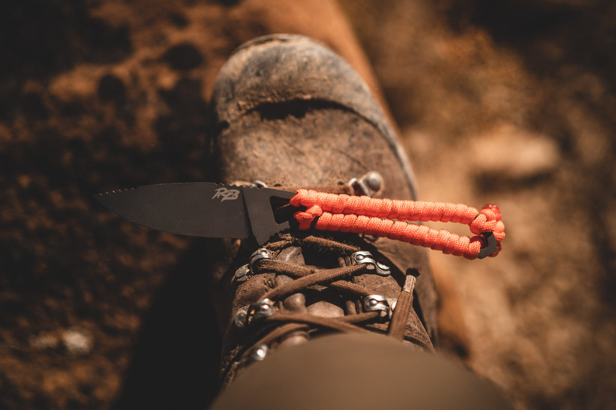 Ultralight Ridge Blade knife with orange paracord lanyard and Ridge Belts logo on black blade on Tampa Home & Garden Store