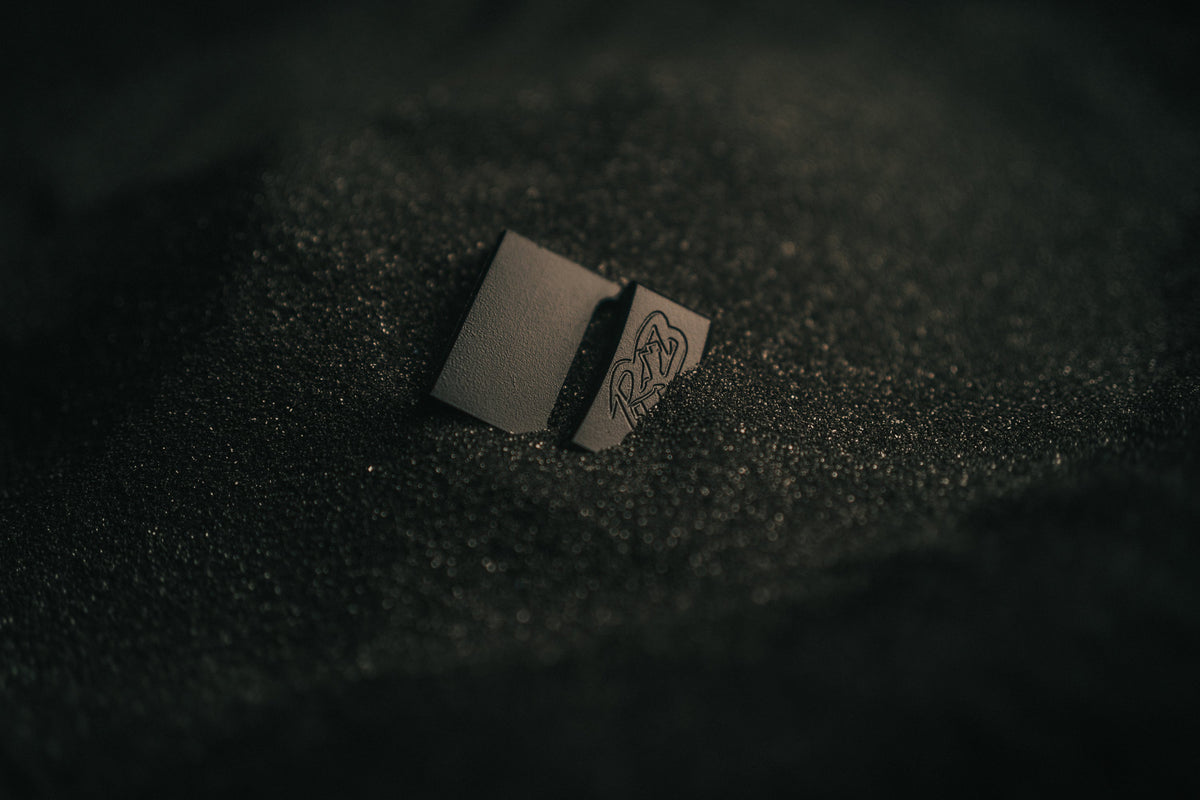 MTN LITE buckle by Ridge Belts, small matte black metal buckle on textured dark surface on Tampa Home & Garden Store