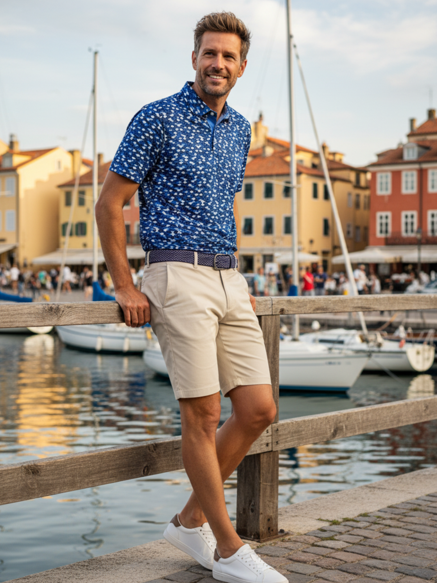 Scales Polo by White Water Life, blue patterned short-sleeve polo worn with beige shorts by dock on Tampa Home & Garden Store