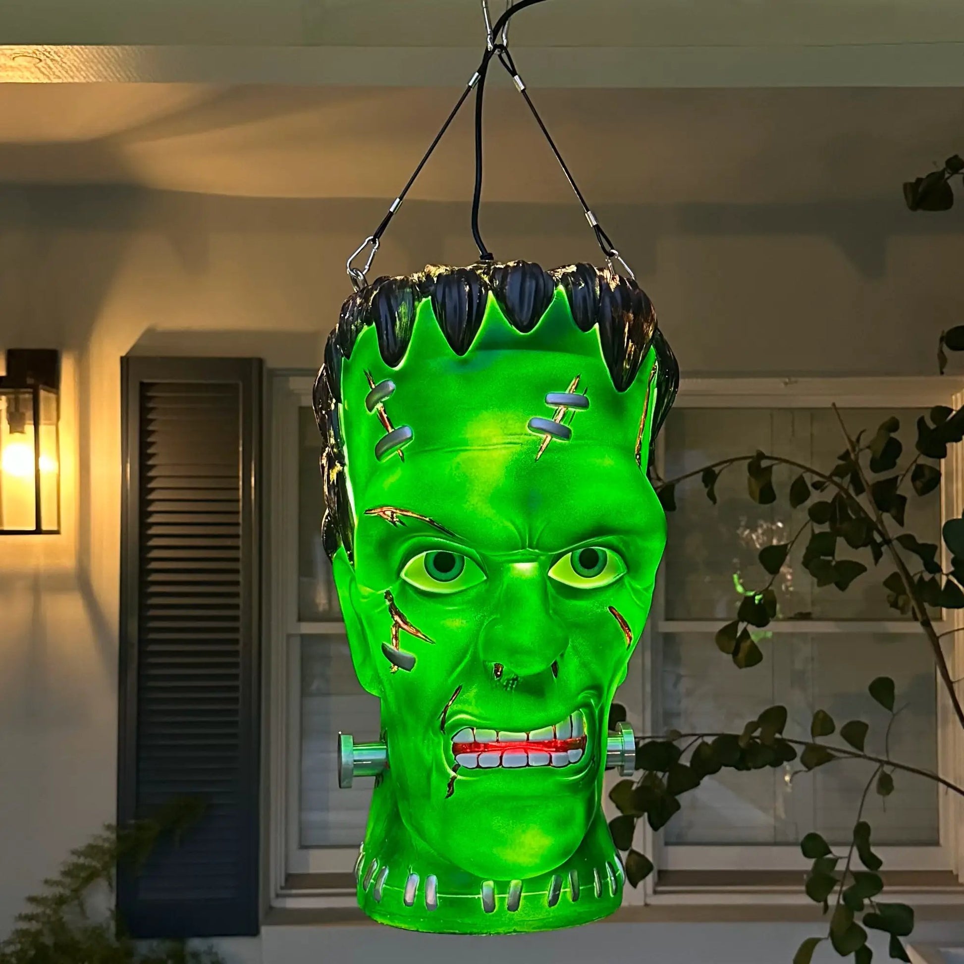 Giant Frankenstein pendant lantern by SCREAMIUM in neon green with stitched seams and bolts on Tampa Home & Garden Store