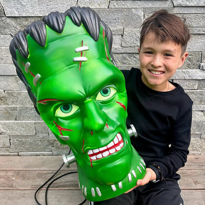 Giant green Frankenstein pendant lantern with black hair and teeth for Halloween decor on Tampa Home & Garden Store