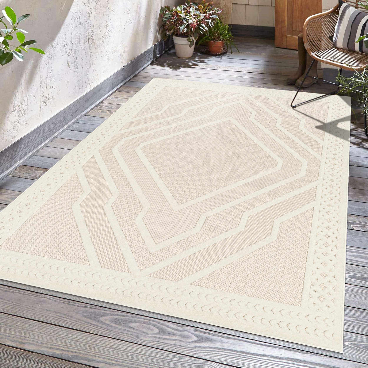 Anja Cream Outdoor Rug by Boutique Rugs with a geometric cream pattern on a wooden porch on Tampa Home & Garden Store
