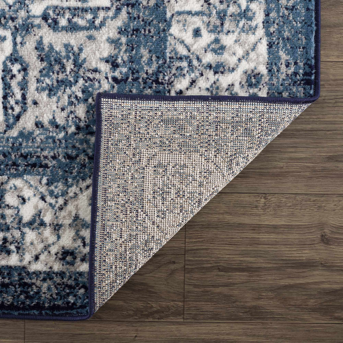 Billy Area Rug by Boutique Rugs, blue and white distressed pattern with navy edge on Tampa Home & Garden Store