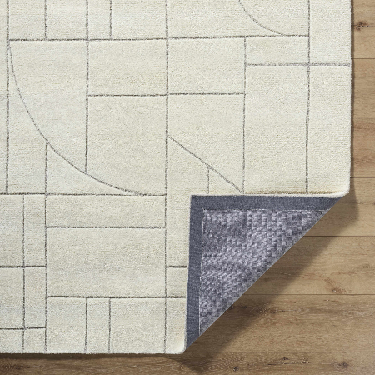 Fusao Off White Area Rug by Boutique Rugs with gray grid pattern on wood floor on Tampa Home & Garden Store