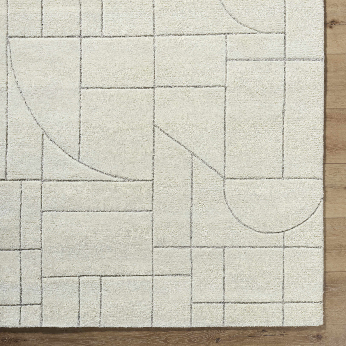 Fusao Off White Area Rug with gray geometric grid pattern by Boutique Rugs on wood floor on Tampa Home & Garden Store