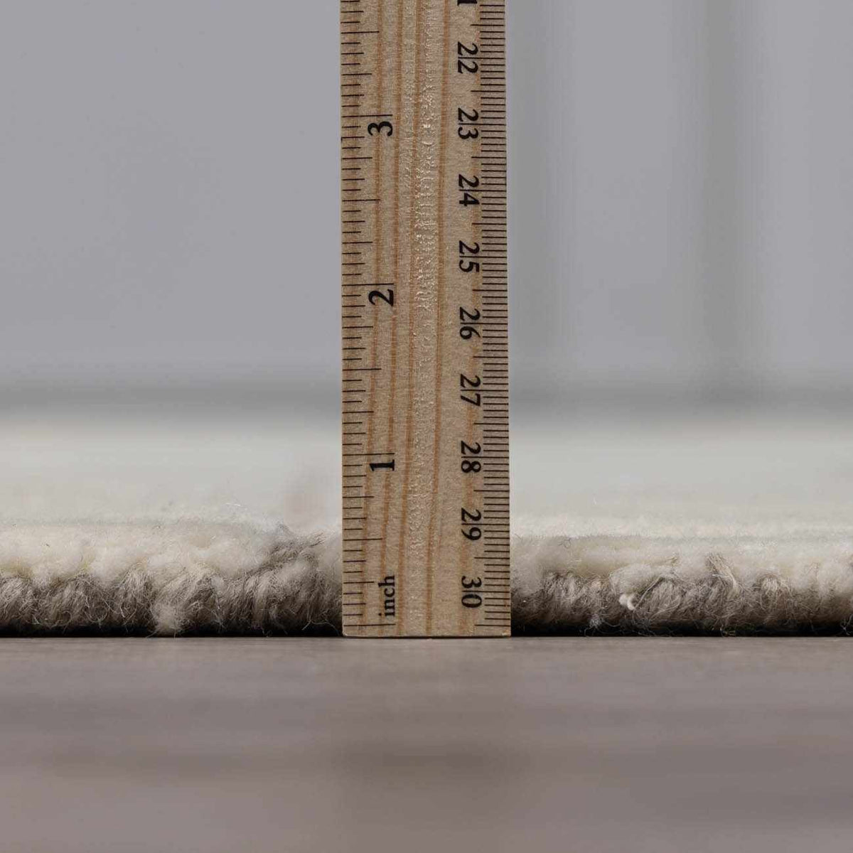 Fusao Off White Area Rug plush shag pile by Boutique Rugs with wooden ruler for scale on Tampa Home & Garden Store