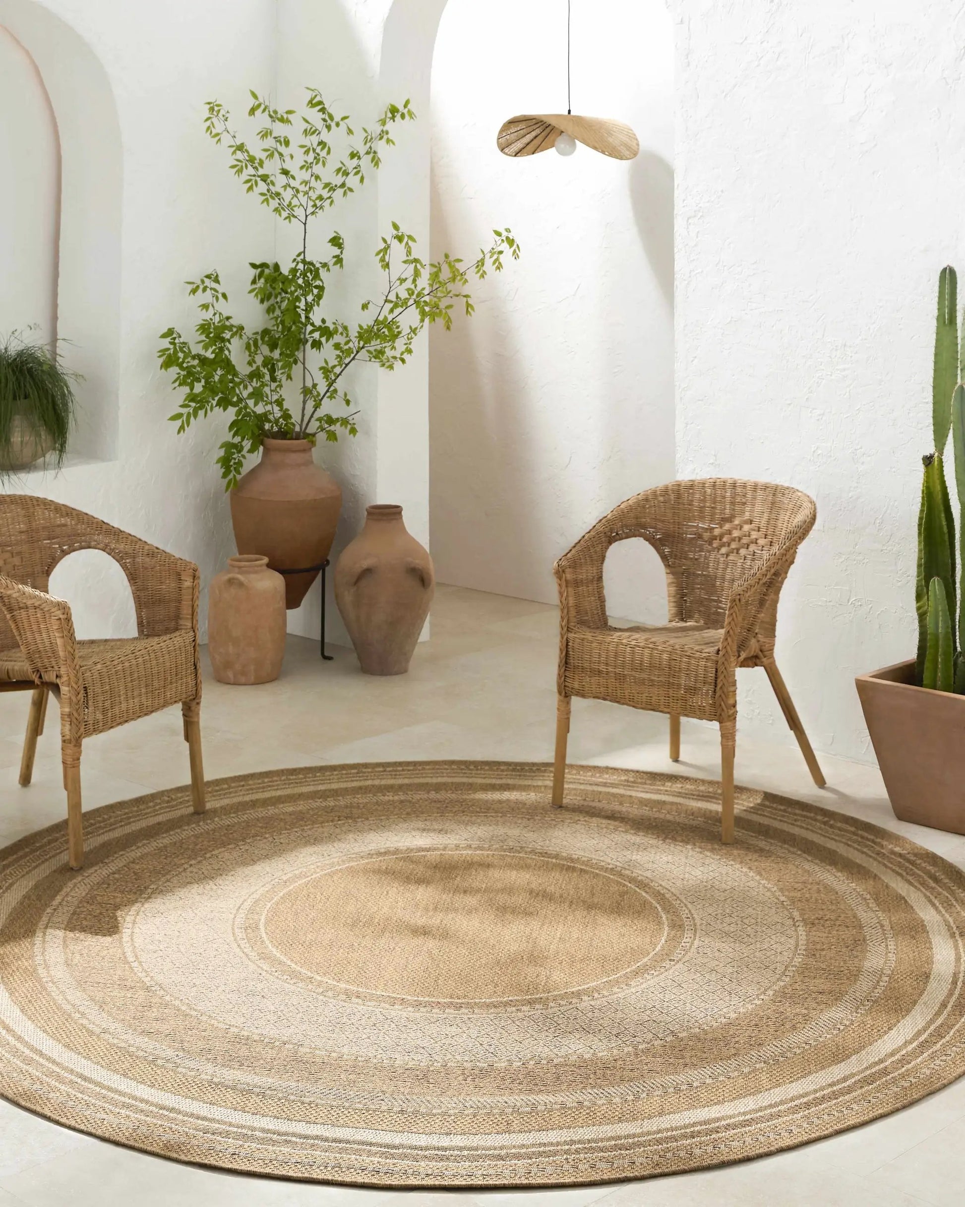 Chael Flatweave Faux Jute Outdoor Rug natural round outdoor rug with braided rings Boutique Rugs on Tampa Home & Garden Store